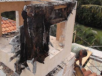 Decorative wood framed chimney with stucco veneer rotted and destroyed